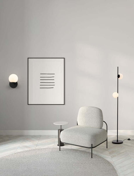 Elegant living room with Nuvole LED wall light 3000K black, white, modern chair and floor lamp.