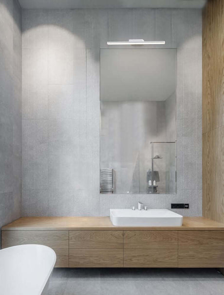 Modern bathroom view with Nyx LED wall light 3000K IP44 above the mirror.