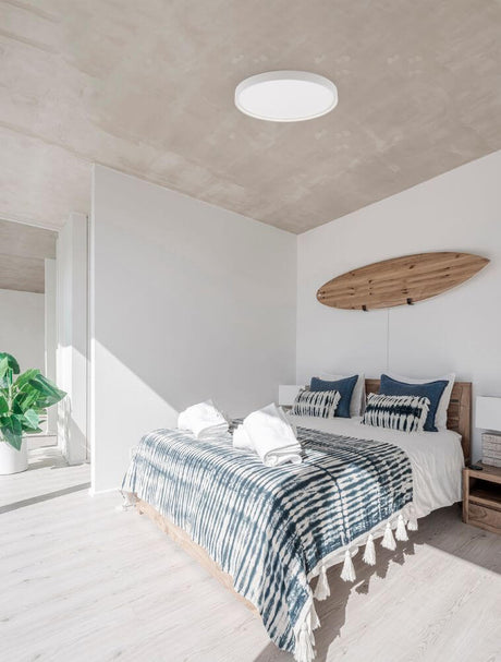 Olaf LED ceiling light Ø 60 cm 3000K in a modern bedroom with a black metal shade and warm white light