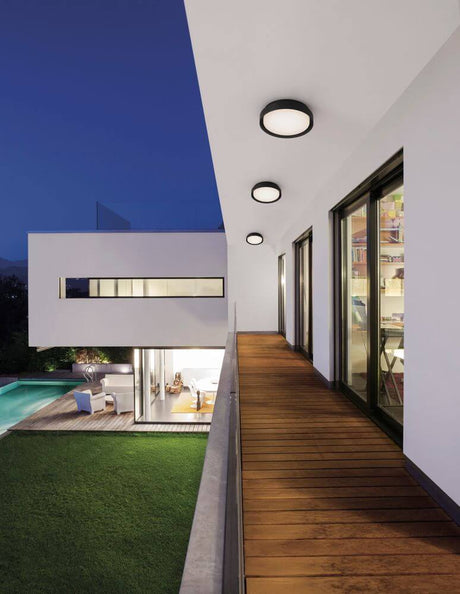 Oliver LED outdoor wall light 3000K IP65 on a modern house façade, round wall/ceiling lights on a balcony canopy, weather-resistant design