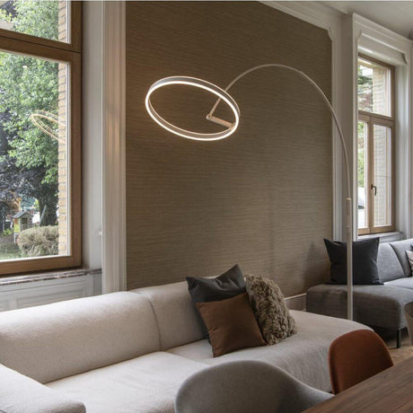One Bow LED Ring arc floor lamp placed in a modern living room above a couch.