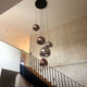 s.luce Orb glass ball pendant light - Stylish pendant light with various glass balls in a modern staircase.