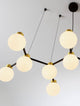 Ovalino Pendelleuchte 14-flammig Gold-Satiniert, Schwarz, Weiß mit Opal-Glaskugeln und mattschwarzen Aluminiumarmen.
