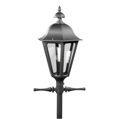 Cabeza de luz Pallas para farola de 69 cm en negro, colocada en un mástil con color ahumado.