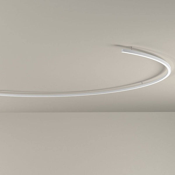 Panzeri Brooklyn semi-ring LED ceiling lamp in a semicircular design on a neutral ceiling.