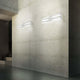 Panzeri Cross LED Wandlampe indirekt und direkt, moderne Designer Wandleuchte an Betonwand.