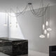 Panzeri Emma pendellampe med retro glass i moderne rom over svart bord