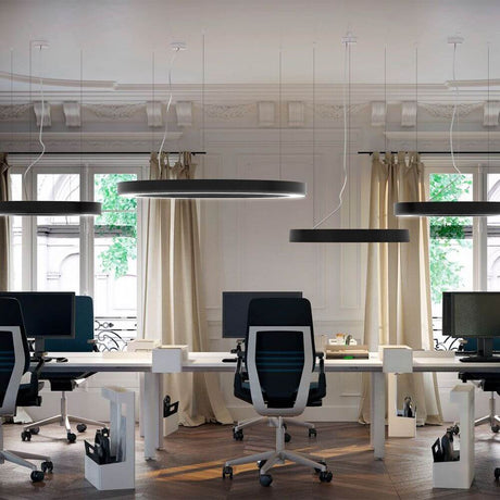 Modern office environment with Panzeri Silver Ring LED pendant lamp, dimmable, above desks.