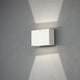 Pavia LED Außenwandleuchte in Weiß an einer Wand installiert, mit sanftem Lichtschein.