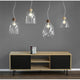 Pendellampe Campana Nussbaum, Transparent über einem modernen Sideboard in einem stilvollen Wohnraum.