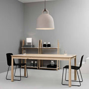 Hanglamp Bell M Ø 42cm Zand boven een moderne eettafel in een minimalistische ruimte