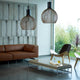 Pendelleuchte Octo Small 4241 aus Holz Ø 45cm in modernem Wohnzimmer mit Sofa und Kaffeetisch.