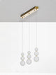 Perla LED Pendelleuchte Balken 70cm 9-flammig 3000K Gold mit runden Opalglas-Elementen und goldenem Metall.
