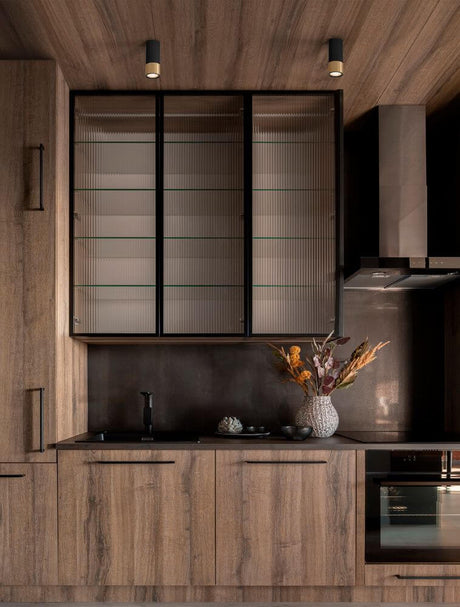 Picto ceiling light GU10 Ø 6cm Black, Gold in a modern kitchen above the worktop with wooden cabinets and a vase arrangement