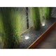 Plug & Shine LED Bodeneinbauleuchten in einem Garten mit Gräsern und Kies, ideal für smarte Gartenbeleuchtung.