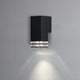 Pollux Außen Wandleuchte IP44 in Schwarz an einer grauen Wand installiert, mit elegantem Lichtstrahl.