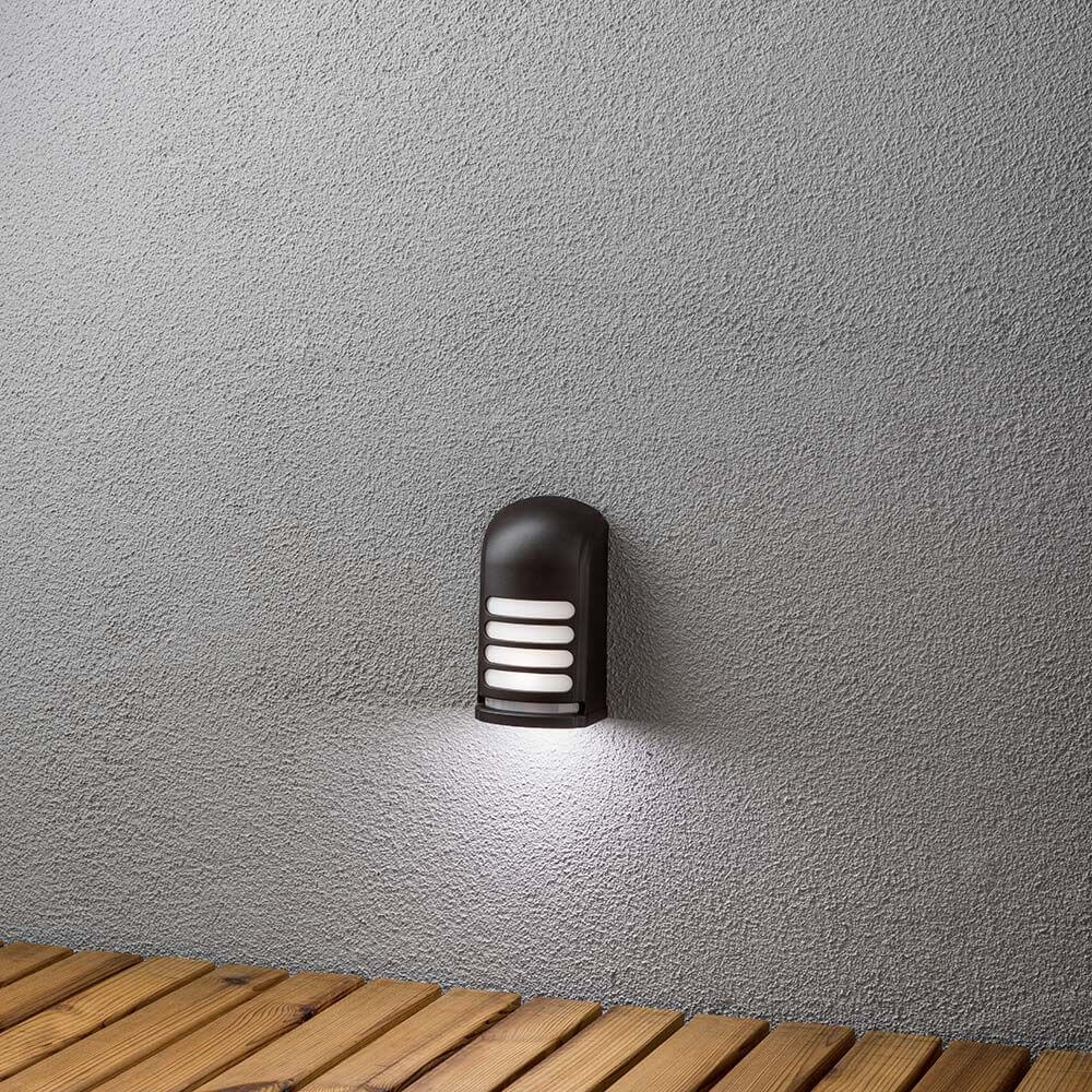 Prato Batterie LED Sensor Außen-Wandaufbauleuchte Schwarz an einer Wand montiert, ideal für Außenbereiche.