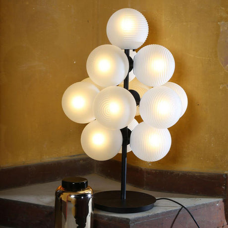 Pulpo LED table lamp Stellar Grape Small 13-light with 13 white glass spheres on a black base.