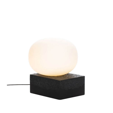 Pulpo LED Magma Two Low table lamp Ø 41 cm H 46 cm on a black base with soft lighting.