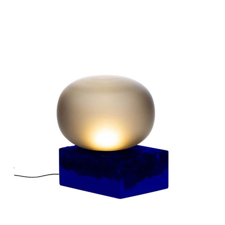 Pulpo LED Magma Two Low table lamp Ø 41 cm H 46 cm on a blue ceramic base with soft light.