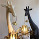Giraffe in Love XS Stehleuchte 100cm - zwei Giraffen mit Kronleuchtern im Maul im modernen Design