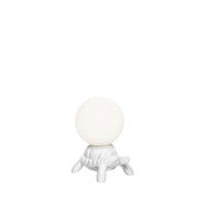 Turtle Carry XS LED rechargeable table lamp on a white turtle with a glowing sphere.