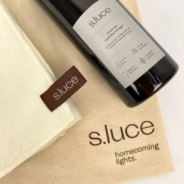 s.luce Universal luminaire cleaner set with cleaning bottle and cloth on a light surface.