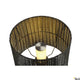 Blick auf die Adegan Manila Outdoor Stehlampe IP44 Rattan mit modernem, geflochtenem Design und strahlendem Licht.