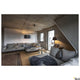 Fenda Bow Basis E27 Bogenleuchte Schwarz (ohne Schirm) über Sofa in modernem Wohnzimmer, gebogener Arm und massive Bodenplatte sichtbar
