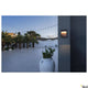 Flatt Sensor LED Outdoor-Wandlampe 3000K Anthrazit, Braun an einer Wand im Außenbereich mit Palmen.