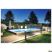 L-Line LED bollard light Pole Anthracite CCT IP65 illuminates an elegant pool area outdoors.