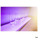 New Flat LED Wandaufbauleuchte 90cm RGBW beleuchtet Gläser auf einem Regal in lila Farbton.