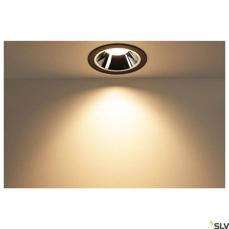 Numinos Diffuser Ellipse in a modern room, casting a soft beam of light onto the wall.