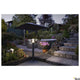 Ovalisk Outdoor LED Pollerleuchte CCT-Switch IP65 in einem stilvollen Garten bei Nacht.