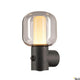 Ovalisk Sensor LED Wandaufbauleuchte Outdoor CCT mit echtem Glas und modernem Design für Außenbereiche.