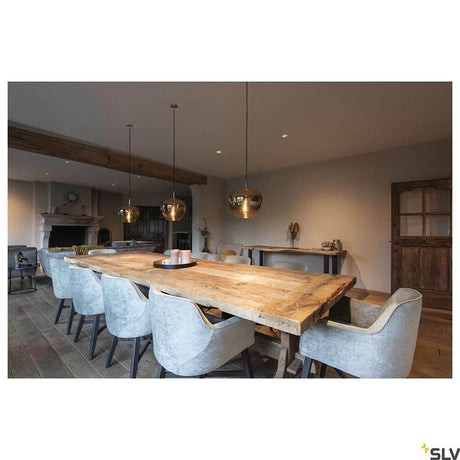 Modern dining room scene with Pantilo Convex pendant light chrome above a large wooden table.