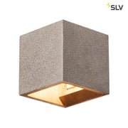 Solid Cube wall light QT14 sandstone in a cubic concrete form with gold interior finish.