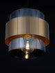 Alt Tag: Sianna Pendelleuchte Ø 18cm Gold, Rauch, Schwarz – zylindrischer Rauchglas-Lampenschirm mit goldfarbenem Metallring, warmes Ambiente-Licht