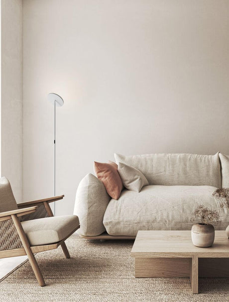 Sinkro LED floor lamp Ø 25.2 cm 3000K with rotary switch in a modern living room setting with a slim white aluminum light next to sofa