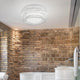 Slamp Decken- & Wandlampe Kalatos Ø 63cm im Badezimmer mit Backsteinwand und freistehender Badewanne