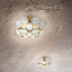 Slamp Decken- & Wandlampe Mida in gold und weiß, elegante Struktur inspiriert von hochwertigem Schmuck.