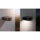 Solar LED Außenwandleuchte Eileen Sensor Schwarz an einer Wand montiert, bietet warmweißes Licht und Bewegungssensor.