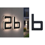 Solar LED house number light letter B black mounted on a house wall, stylish design with indirect lighting.