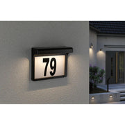 Solar LED house number light Dayton II Black with the number 79 mounted on a wall