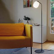 Modern living room view with the Casablanca floor lamp Murea Ø 13cm anthracite next to a yellow sofa.