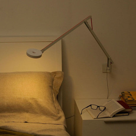Rotaliana String LED wall light with dimmer White above the bed with warm light and a bedside table.