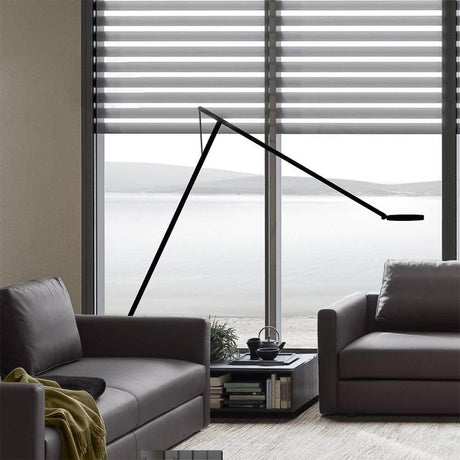 Rotaliana String XL LED floor lamp with dimmer in black-orange in a modern living room with windows.