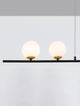 Sway Pendelleuchte Gold, Weiß, Schwarz mit zwei opalen Glaskörpern und handgebürsteter Aluminiumleiste.