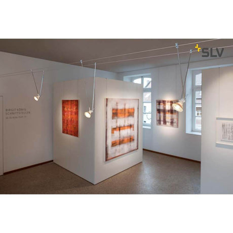 Telescopic cable light for Tenseo 12V cable system, white, in a gallery with works of art