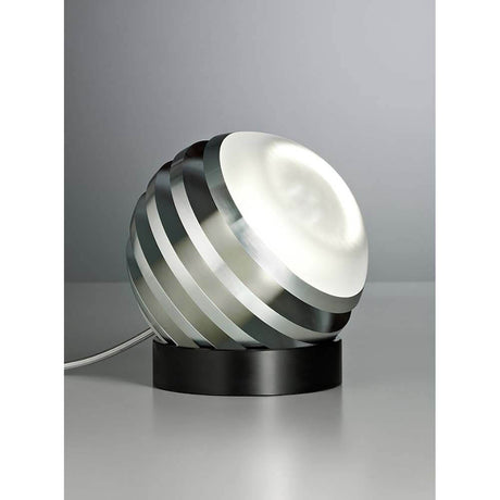 Tecnolumen LED-bordlampe Bulo Ø16 cm på et bord med matt aluminium og satinert glass.